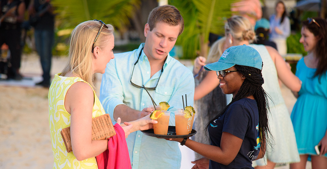 Couple is served tropical cocktail from server at Blanchards private event