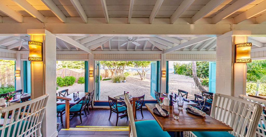 Seating inside Blanchards restaurant with window open to the beach
