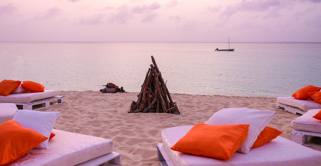 Bonfire on meads bay beach with cushions for seating at sunset and dusk