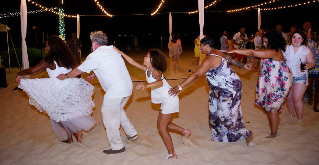 Blanchards wedding guests dance conga line on the beach