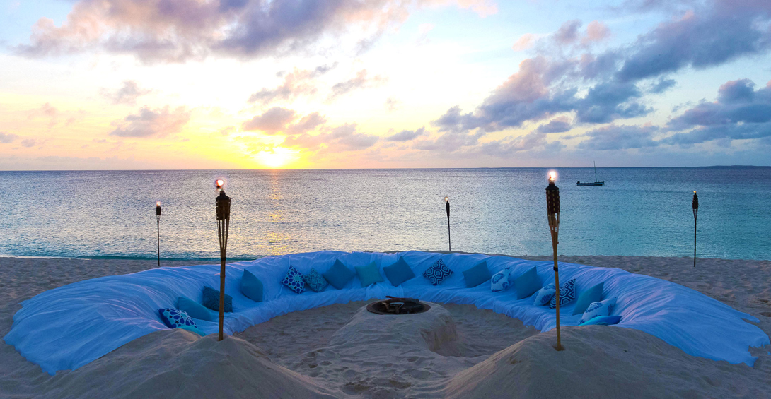 Sand sofa carved on the beach at sunset. Meads Bay beach in Anguilla at Blanchards private event.